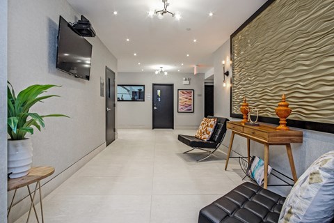 a living room with a table and chairs and a television